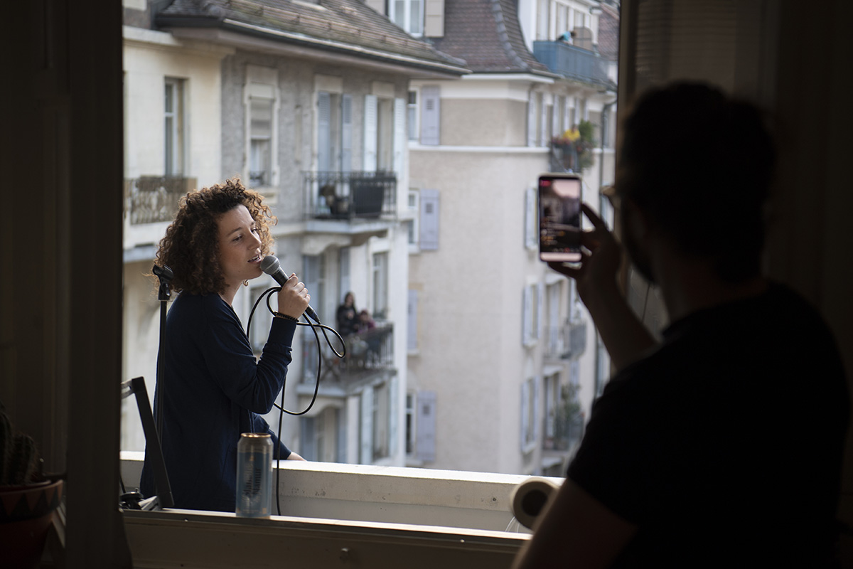 412817043 – Keystone-SDA/Laurent Gilliéron - Die Schweizer Sängerin und Halbfinalistin der französischen TV-Reality-Show «The Voice» im Jahr 2016, Amandine (Rapin) gibt ein kurzes Konzert auf ihrem Balkon in Lausanne, 28. März 2020.
