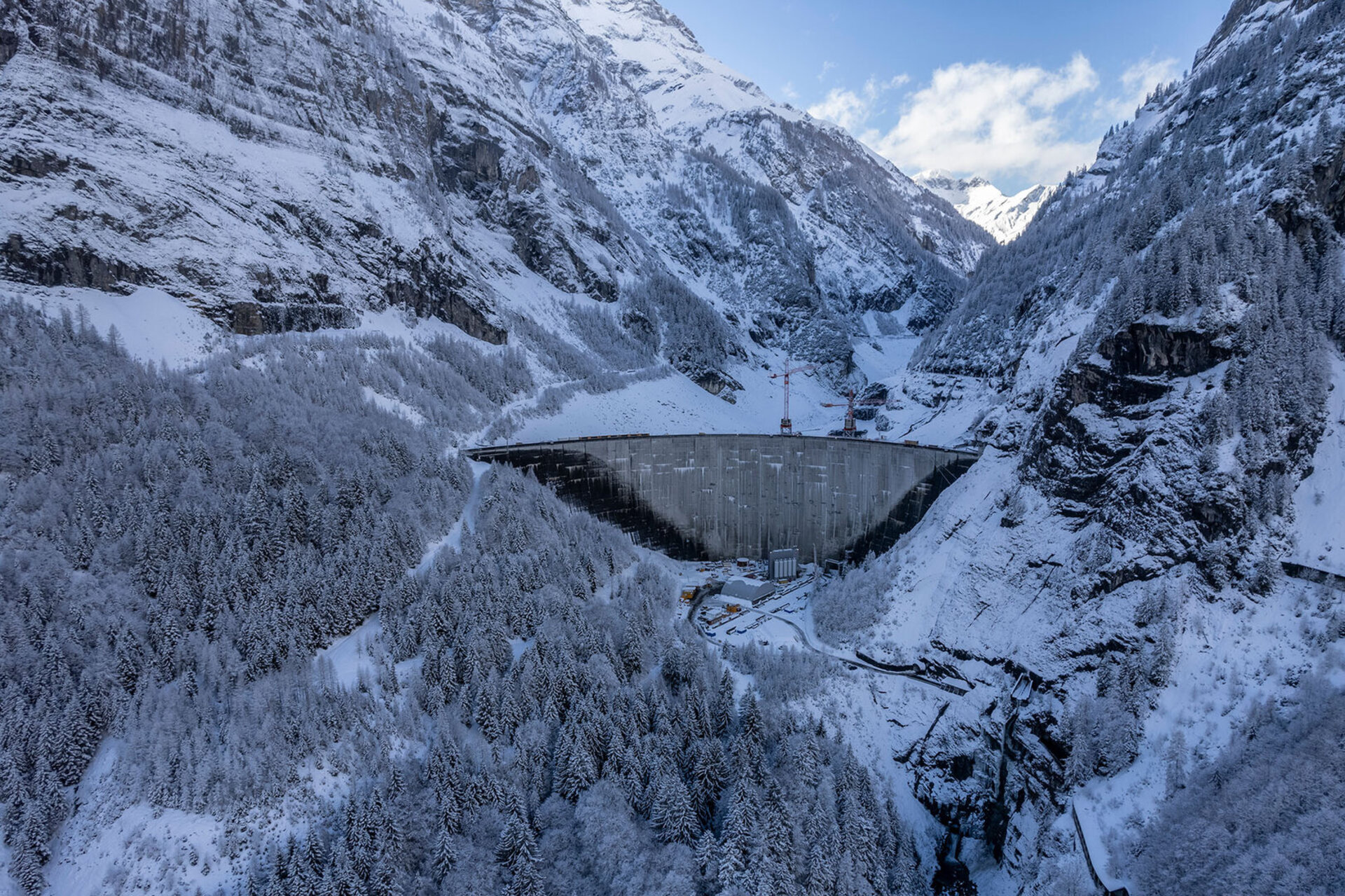 Hier sind die Übersetzungen für Keystone-SDA und Keystone-ATS: Englisch (Amerikanisch) A panoramic aerial view of the massive Gigerwald dam of Axpo, stretching between steep, snowy mountain slopes in a wintry mountain landscape. Französisch Une vue aérienne panoramique du massif barrage de Gigerwald d'Axpo, s'étendant entre des versants montagneux escarpés et enneigés dans un paysage alpin hivernal.