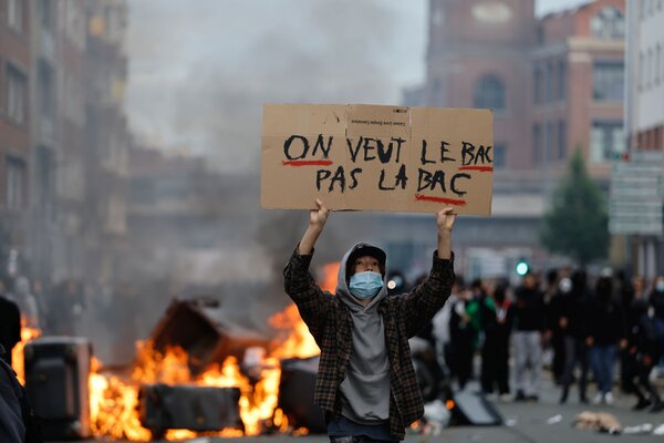 A students holds a board reading, "we want the BAC (High School Diploma) Not the BAC (Anti-criminality units)" during a protest to demand more resources at school, in Lille, France, Thursday, Oct. 1, 2026
