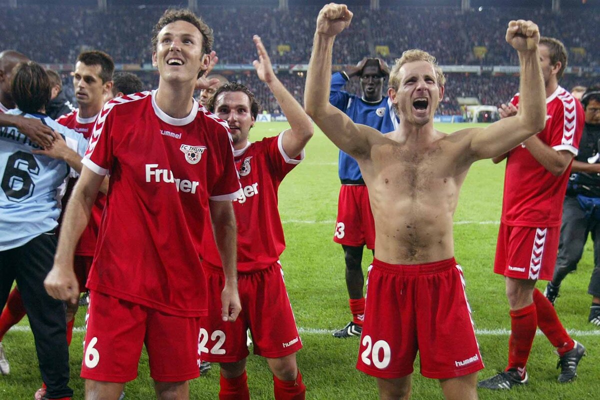 Thun's scorers Tiago Bernardini, left, and Mauro Lustrinelli, celebrate with their fans after Thun's 3:0 victory after the UEFA Champions League, third qualifying round second leg soccer match opposing FC Thun to Malmoe FF in the Stade de Suisse Wankdorf in Bern,