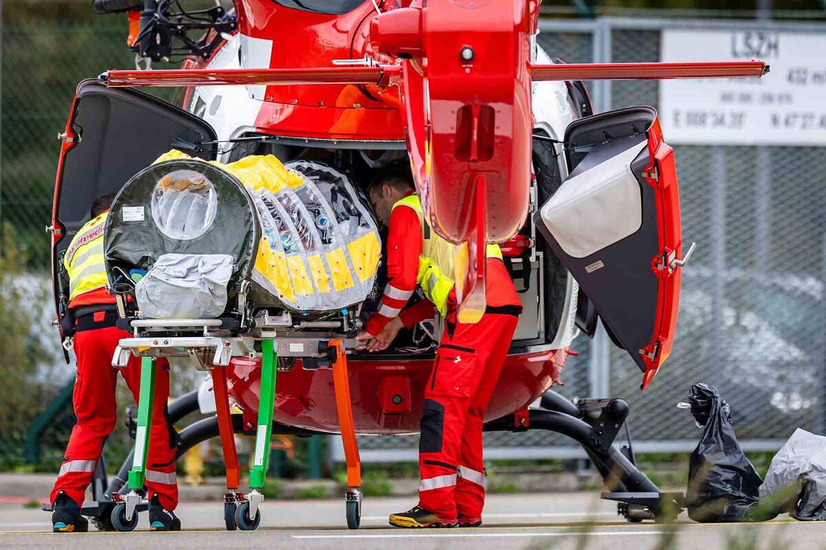 A patient is being transferred in a isolation unit from a rescue aircraft to a rescue helicopter of Swiss Air Rescue (Rega) at Zurich Airport on Monday, October 26, 2026, in Zurich, Switzerland.