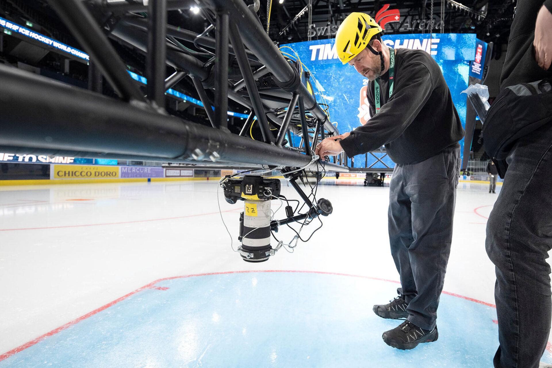 Keystone-SDA photographer Michael Buholzer setting up a camera with a remote shutter release and transmitter, which will remain mounted on the ceiling of the Swiss Life Arena for the duration of the Ice Hockey World Championship, 11 May 2026 in Zurich, Switzerland. 