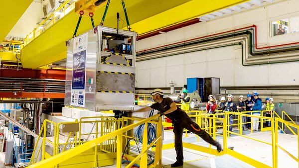 Technicians move the transportable antimatter trap (measuring just 2 metres in length, 1.58 metres in height and 0.87 metres across. Weighing in at 1 tonne) into the Antimatter Factory at the European Organization for Nuclear Research (CERN) for a road test, in Meyrin near Geneva, Switzerland, Tuesday, March 24, 2026. Scientists at CERN (the European Organization for Nuclear Research) transported antimatter by truck for the first time in a never-before-attempted test drive on the road.