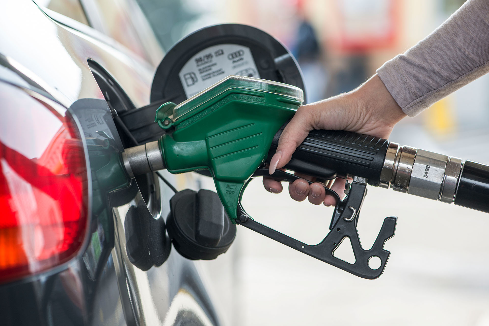 A woman refuels a car at a BP gas station in Kemptthal in the Canton of Zurich, Switzerland.