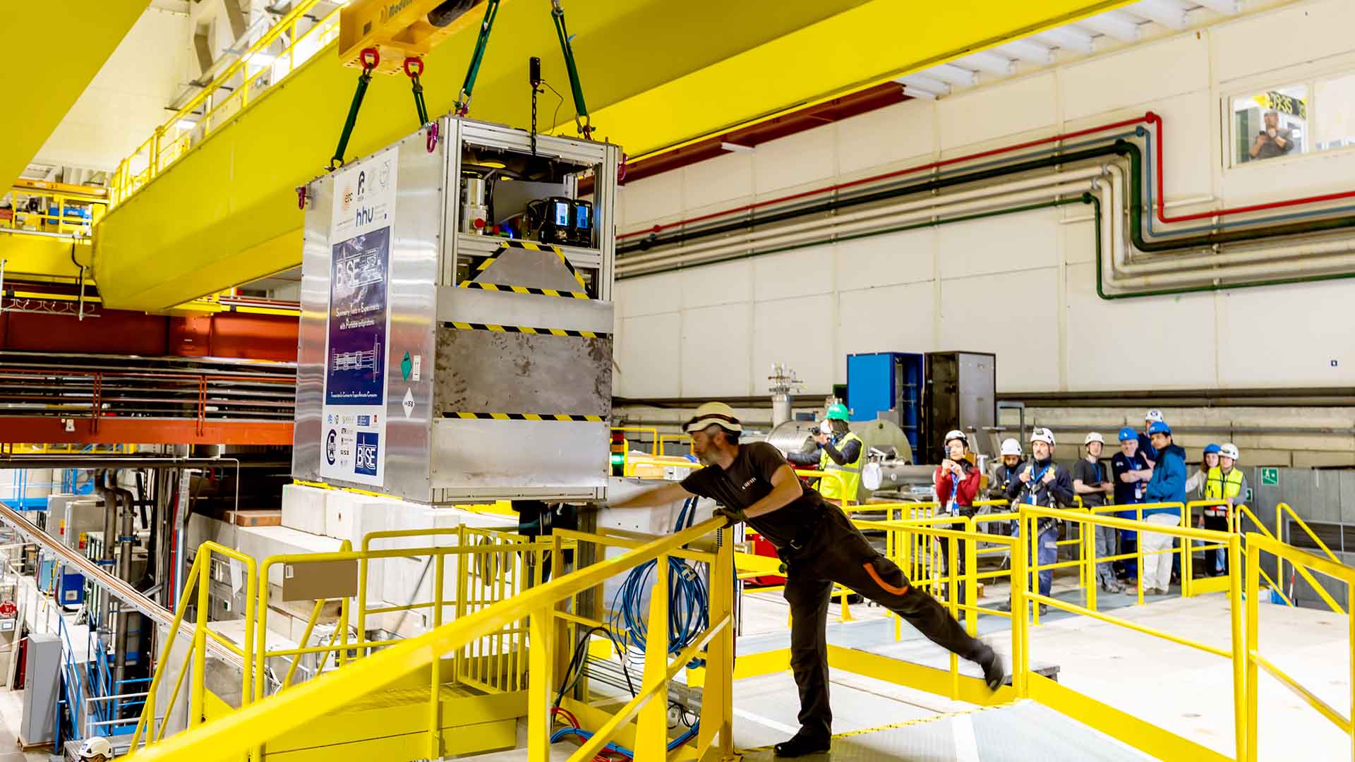 Technicians move the transportable antimatter trap (measuring just 2 metres in length, 1.58 metres in height and 0.87 metres across. Weighing in at 1 tonne) into the Antimatter Factory at the European Organization for Nuclear Research (CERN) for a road test, in Meyrin near Geneva, Switzerland, Tuesday, March 24, 2026. Scientists at CERN (the European Organization for Nuclear Research) transported antimatter by truck for the first time in a never-before-attempted test drive on the road.