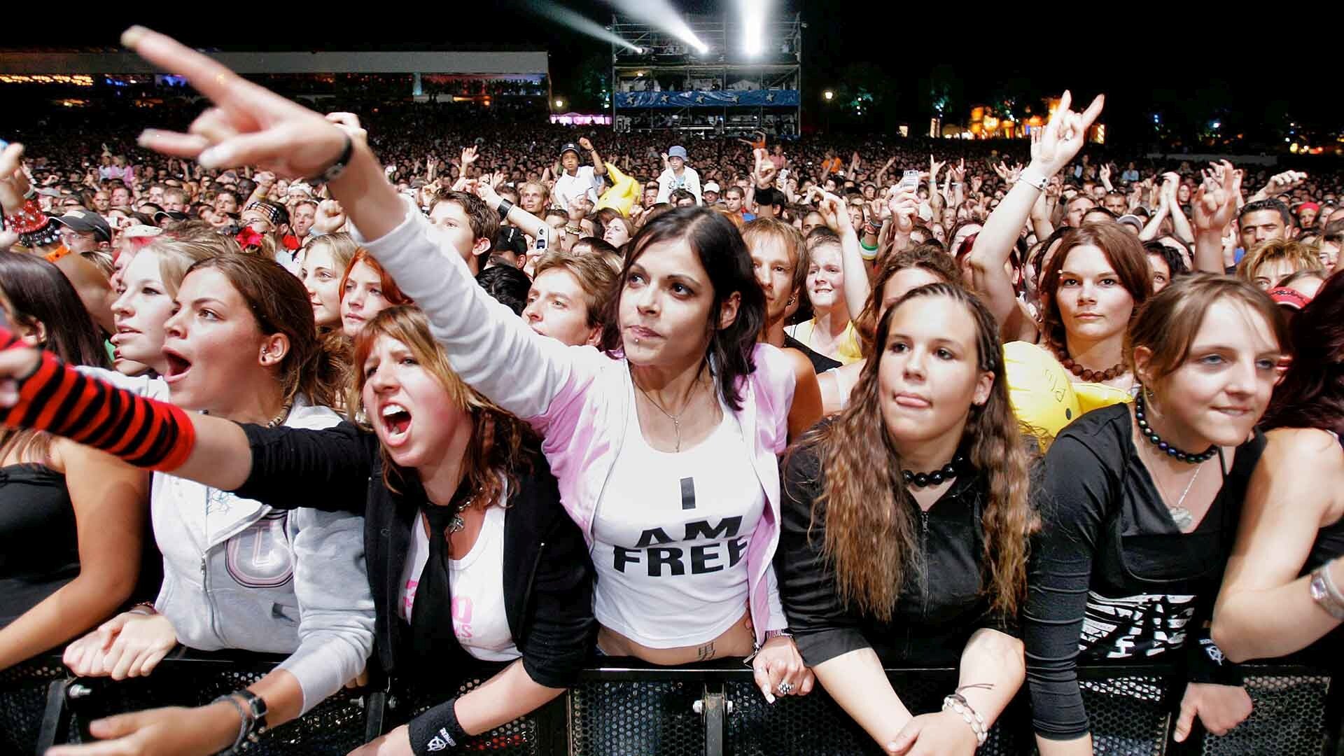 Fans of French singer Kyo in front of the main stage react during the last day of the Paleo Festival, in Nyon, Switzerland, Sunday, July 24, 2005